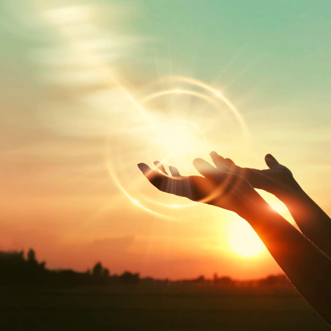 Hands releasing light symbolizing the emotional release and letting go of stress